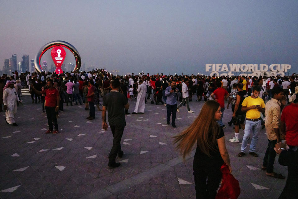 People take photographs in front of the official FIFA World Cup Countdown Clock on Doha's corniche, in Qatar, Friday, Oct. 21, 2022. (AP Photo/Nariman El-Mofty)