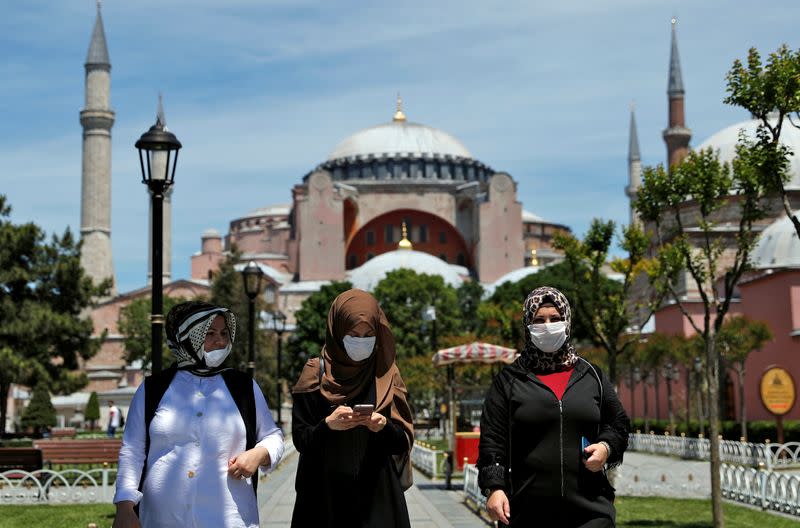 FILE PHOTO: Women wearing face masks stroll at Sultanahmet Square in Istanbul