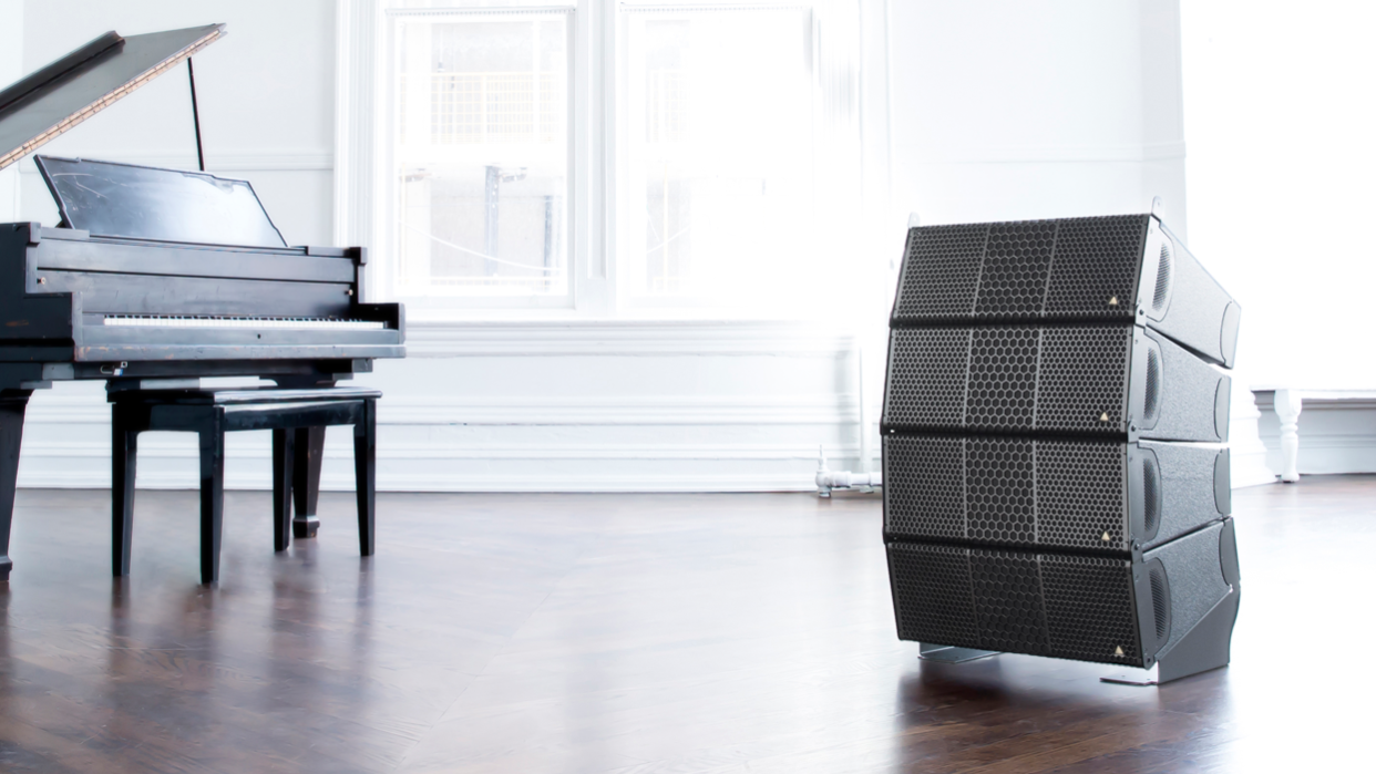  The latest addition to the Adamson IS-Series loudspeakers next to a piano.  