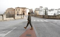 A Spanish legionnaire patrols in an empty Puente Nuevo in downtown Ronda