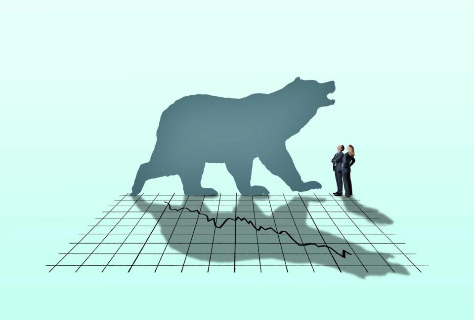 Silhouette of a bear against a stock market downturn chart.