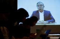 A video statement made by the former Nissan Motor chairman Carlos Ghosn is shown on a screen during a news conference by his lawyers at Foreign Correspondents' Club of Japan in Tokyo