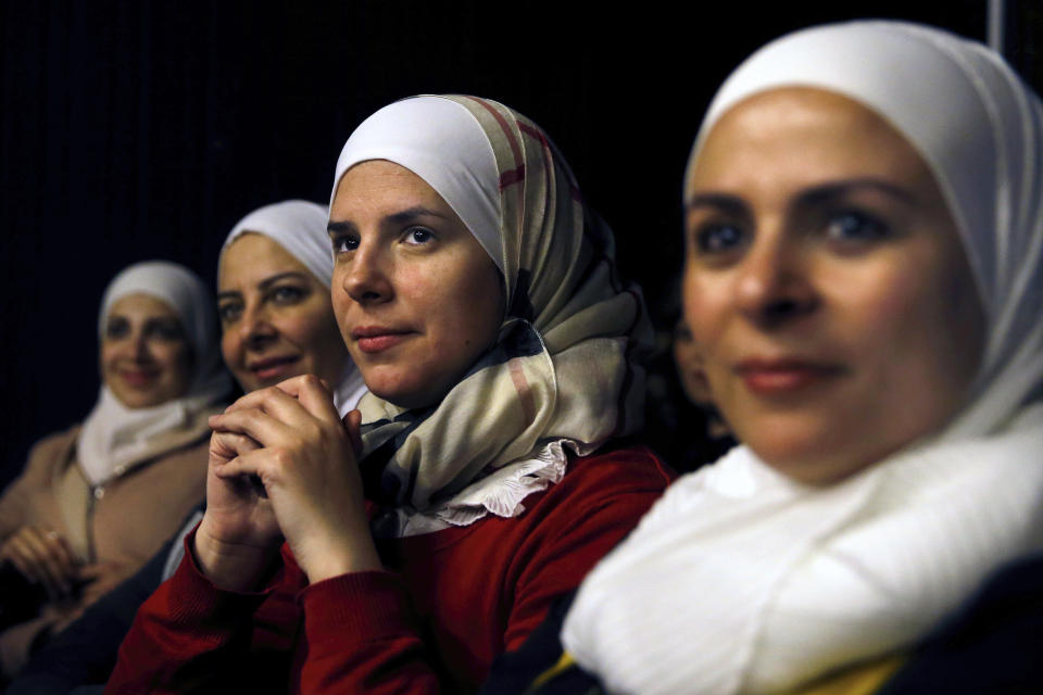 In this Friday, Feb. 8, 2019 photo, a group of Syrian women attend a playback theater at the end of a three-month training session, in Beirut, Lebanon.Syrians from different parts of their war-torn country have gathered inside a theater telling their stories that are later re-acted by a group of Syrians who have been training on playback theater. (AP Photo/Bilal Hussein)