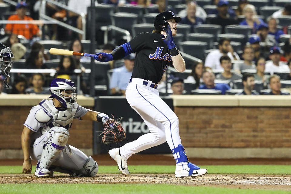 New York Mets' Brett Baty follows through after hitting a home run against the Colorado Rockies during the third inning of a baseball game on Friday, Aug. 26, 2022, in New York. (AP Photo/Jessie Alcheh)