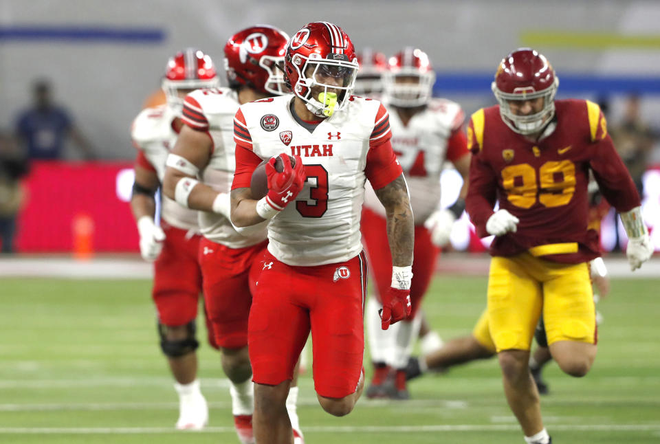 Utah running back Ja'Quinden Jackson (3) runs for a touchdown against Southern California during the second half of the Pac-12 Conference championship NCAA college football game Friday, Dec. 2, 2022, in Las Vegas. Southern California defensive lineman Nick Figueroa is at right. (AP Photo/Steve Marcus)