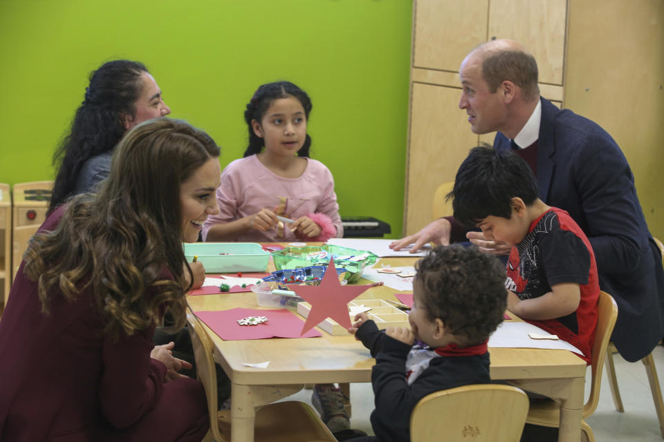 Britain's Prince William and Kate, Princess of Wales, left, chat with participants of the Young Mother's Program at Roca Thursday, Dec. 1, 2022, in Chelsea, Mass. (AP Photo/Reba Saldanha, Pool)