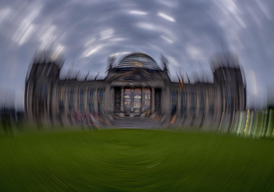 Picture taken while turning the camera shows the Reichstag building with the German parliament in Berlin, Germany, Sunday, Sept. 26, 2021. German elections are held on Sunday. (AP Photo/Michael Probst)