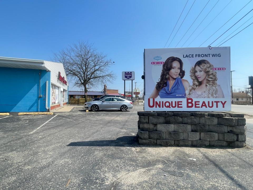 The manager of Unique Beauty, a wig shop directly next door to Motels4Now, said the "chaos" next door is part of the reason he's losing money.