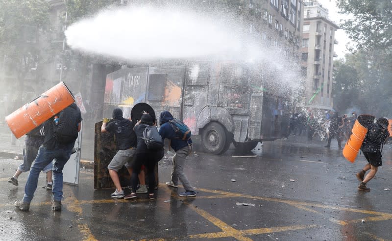 Police clash with demonstrators during a protest against Chile's government in Santiago