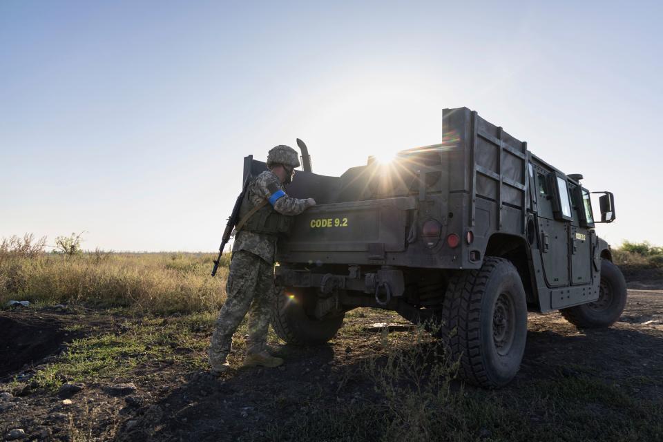 A Ukrainian serviceman known as "Yasha" of "Code 9.2" puts equipment into an armored vehicle at the frontline near Klishchiivka, Donetsk region, Ukraine, Sunday, Sept. 24, 2023.