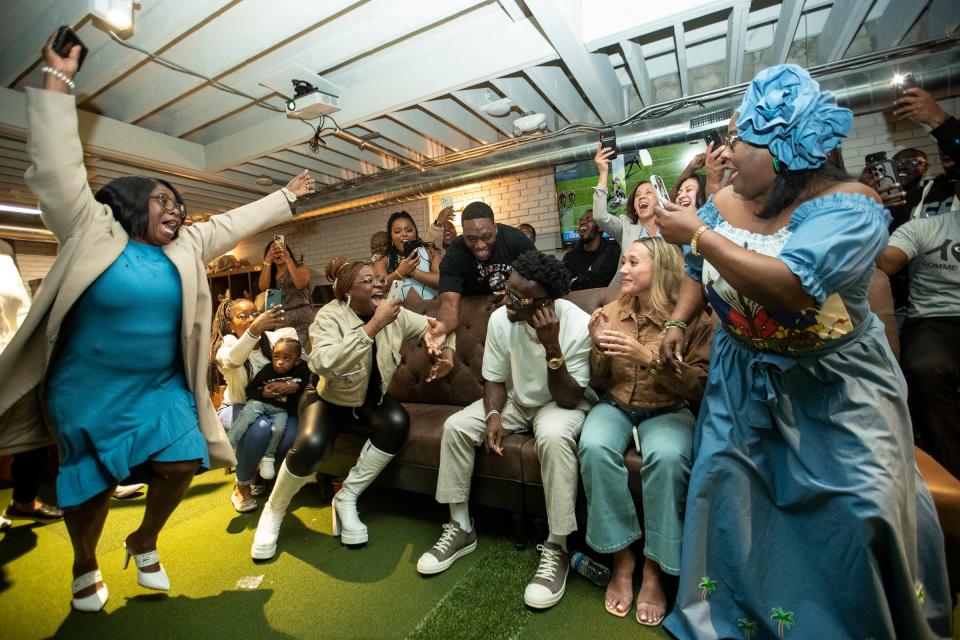 Family and friends celebrate as former Michigan defensive back Mike Sainristil announces that he has been drafted by Washington Commanders in the second round at his NFL Draft watch party in Ann Arbor on Friday, April 26, 2024.