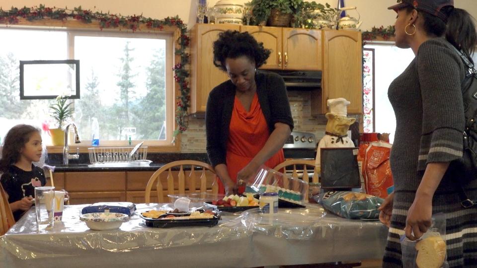 Alaska -Juneau, Alaska - Rena Sims, her daughter Nicole Robinson-Wells and her grandaugter, prepare food at their home in Juneau, Alaska. Sims has fostered over 300 children, many of which have been abused prior to living with her. [Via MerlinFTP Drop]