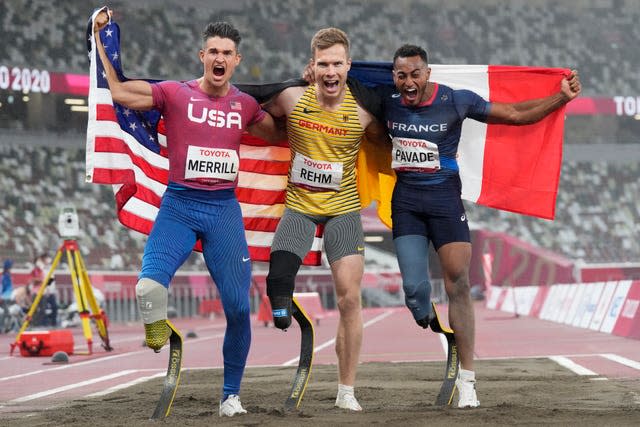 Germany’s Markus Rehm (centre) celebrates gold in the men’s long jump T64 with silver winner Dimitri Pavade (right) and third-placed Trenten Merrill