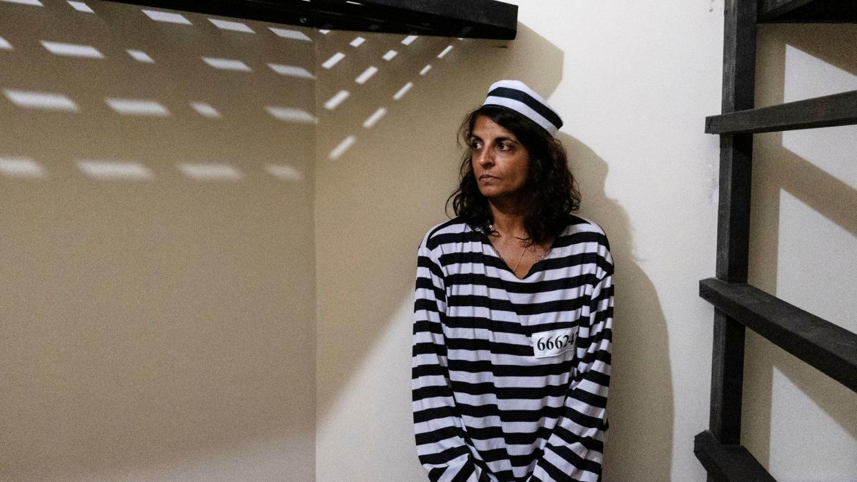 Journalist Nina Lakhani, writes at the "The Dungeon", a hostel prison for guests to pay their crimes against Planet Earth by using plastic bottles.&nbsp; (Photo: Santiago Escobar-Jaramillo for HuffPost)