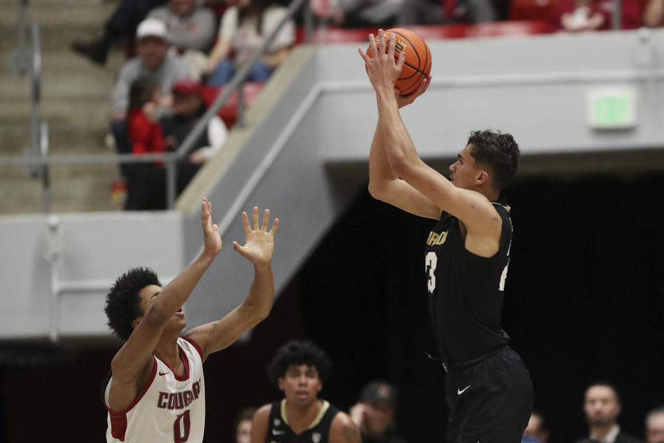 Colorado forward Tristan da Silva, right, shoots while pressured by Washington State forward Jaylen Wells (0) during the second half of an NCAA college basketball game, Saturday, Jan. 27, 2024, in Pullman, Wash. Washington State won 78-69. (AP Photo/Young Kwak)