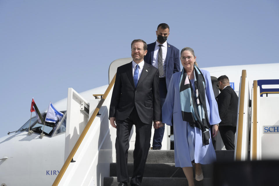 In this photo provided by the Israeli Government Press Office, Israeli President Isaac Herzog and First Lady Michal Herzog arrive to Abu Dhabi, United Arab Emirates,, Sunday, Jan. 30, 2022. Israel's president arrived in the United Arab Emirates on Sunday in the first official visit by the country's head of state, the latest sign of deepening ties between the two nations as tensions rise in the region. (Amos Ben Gershom/GPO via AP)