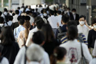 FILE - In this July 12, 2021, file photo, commuters wearing face masks walk in a passageway during a rush hour at Shinagawa Station in Tokyo. The coronavirus is the biggest reason for North Korea’s absence from the Tokyo Games. (AP Photo/Eugene Hoshiko, File)