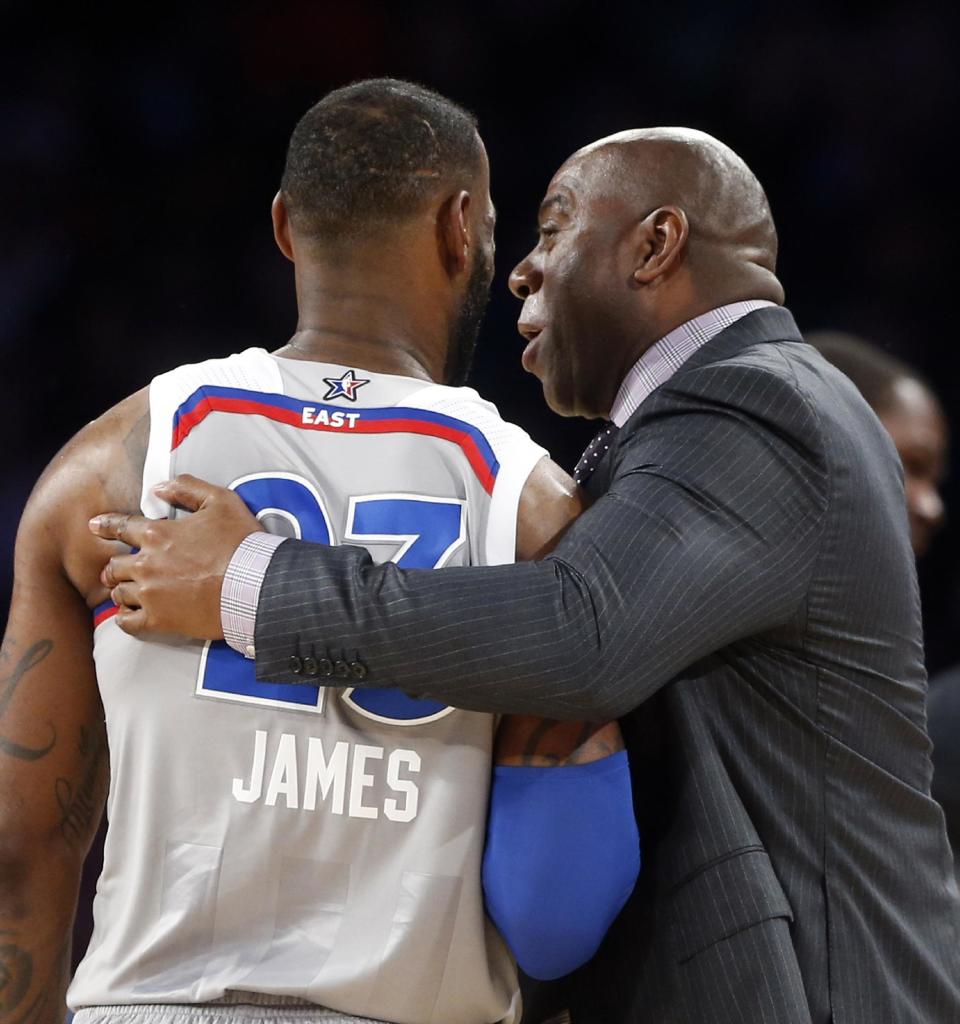 Former NBA player Magic Johnson reacts as he talks with Eastern Conference LeBron James of the Cleveland Cavaliers (23) during the first half of the NBA All-Star basketball game in New Orleans, Sunday, Feb. 19, 2017. (AP Photo/Gerald Herbert)