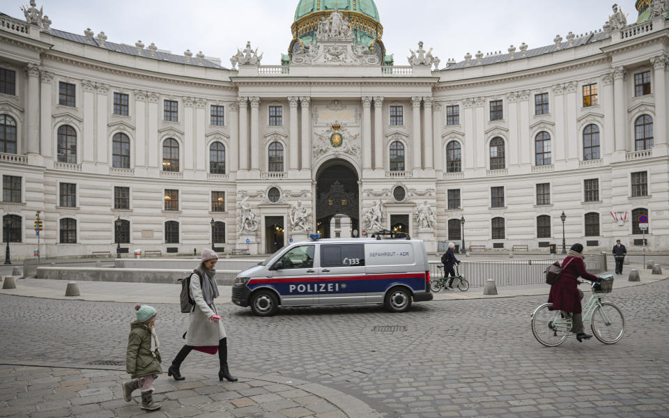 People walk in Vienna, Austria,Monday, Nov. 22, 2021. Austria went into a nationwide lockdown early Monday to combat soaring coronavirus infections, a step being closely watched by other European governments struggling with national outbreaks that are straining health care systems.(AP Photo/Vadim Ghirda)