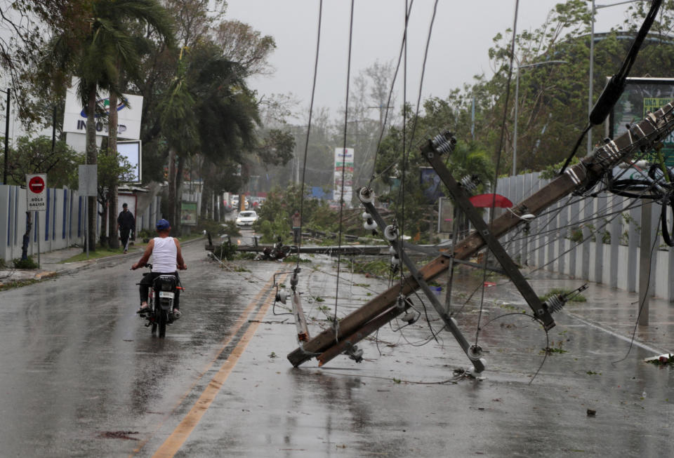 <p>A man on a motorcycle rides past fallen power lines in the aftermath of Hurricane Fiona in Higuey, Dominican Republic, September 19, 2022. REUTERS/Ricardo Rojas</p> 