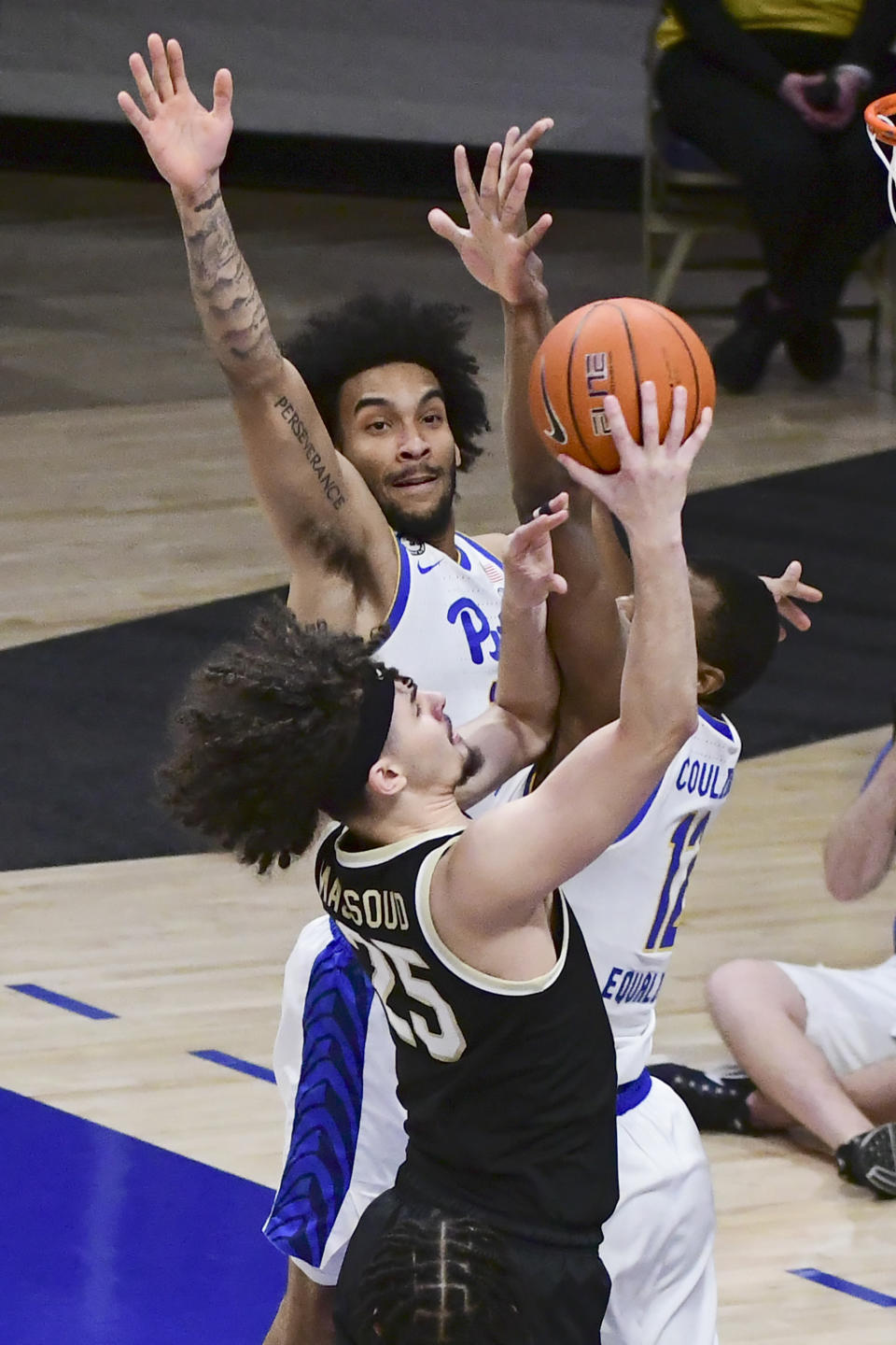 Wake Forest forward Ismael Massoud drives past Pittsburgh forward Justin Champagnie during the first half of an NCAA college basketball game, Tuesday, March 2, 2021, in Pittsburgh. (AP Photo/Fred Vuich)