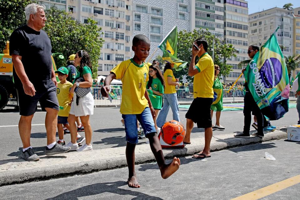 A young boy plays with a soccer ball during rally.