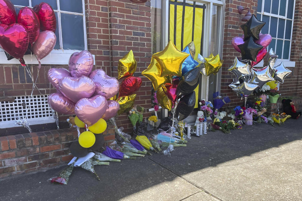 FILE - Flowers and balloons sit piled outside the Mahogany Masterpiece dance studio on Wednesday, April 19, 2023, in Dadeville, Ala. Two teenagers have been arrested and charged with murder in connection with a shooting that killed four young people at a Sweet Sixteen birthday party, (AP Photo/Kimberly Chandler, File)