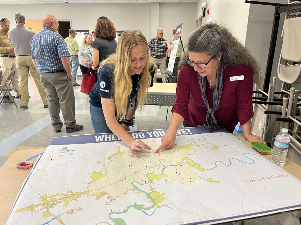 Public health representative Sophie Carter and City of Knoxville Neighborhood Coordinator Debbie Sharp examine a map of Knoxville neighborhoods at Trees Knoxville’s latest Urban Forest Master Plan meeting May 11 at Cansler YMCA.