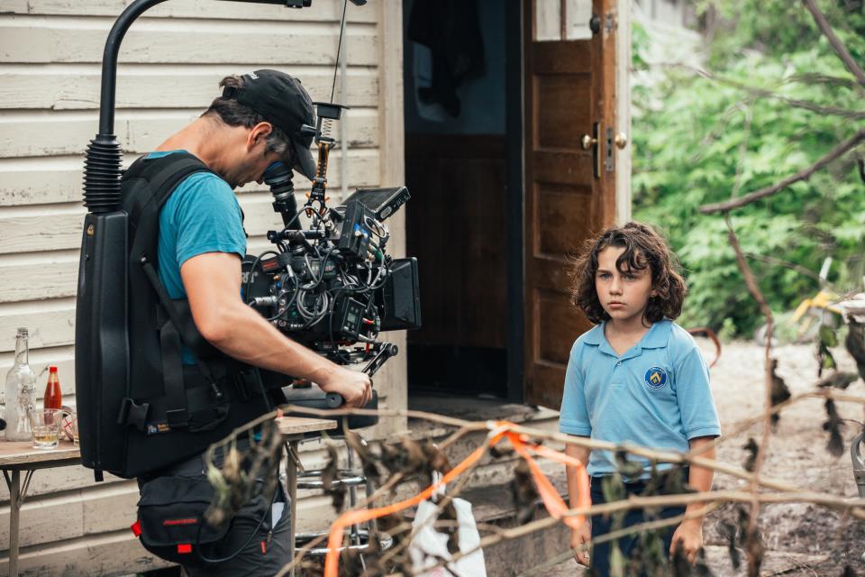 Devin France being directed on set.