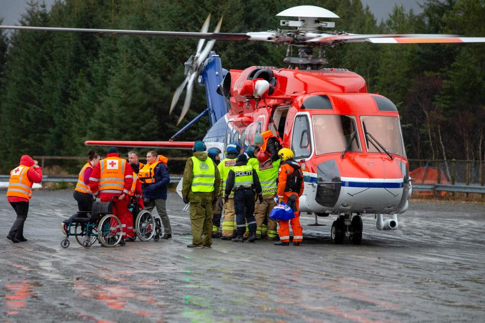 Rescuers wait to assist passengers airlifted by helicopter from the cruise ship Viking Sky on March 24, 2019 off the west coast of Norway.