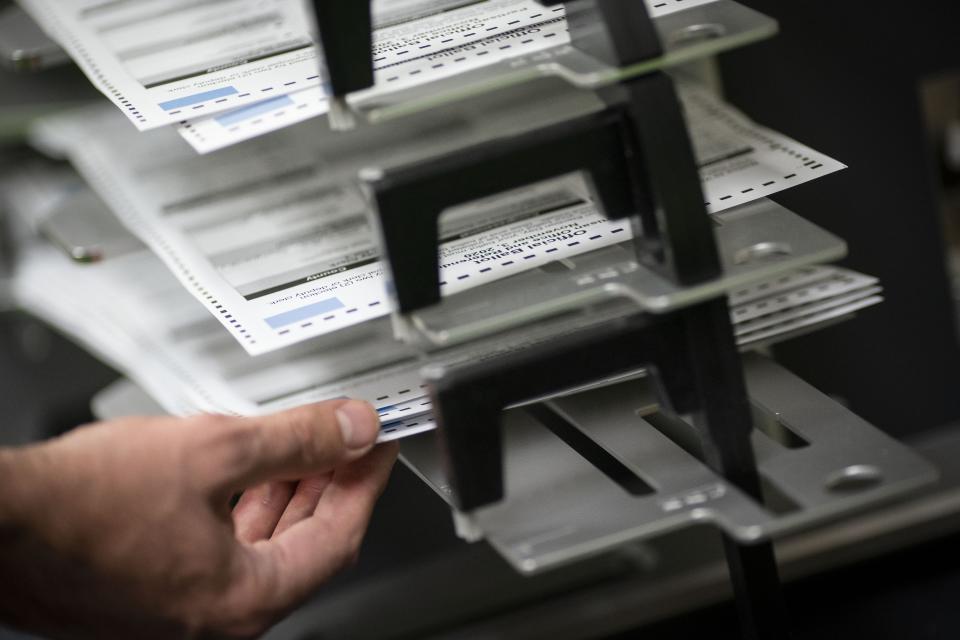 Poll workers sort out early and absentee ballots at the Kenosha Municipal building on Election Day on Tuesday, Nov. 3, 2020, in Kenosha, Wis. (AP Photo/Wong Maye-E)