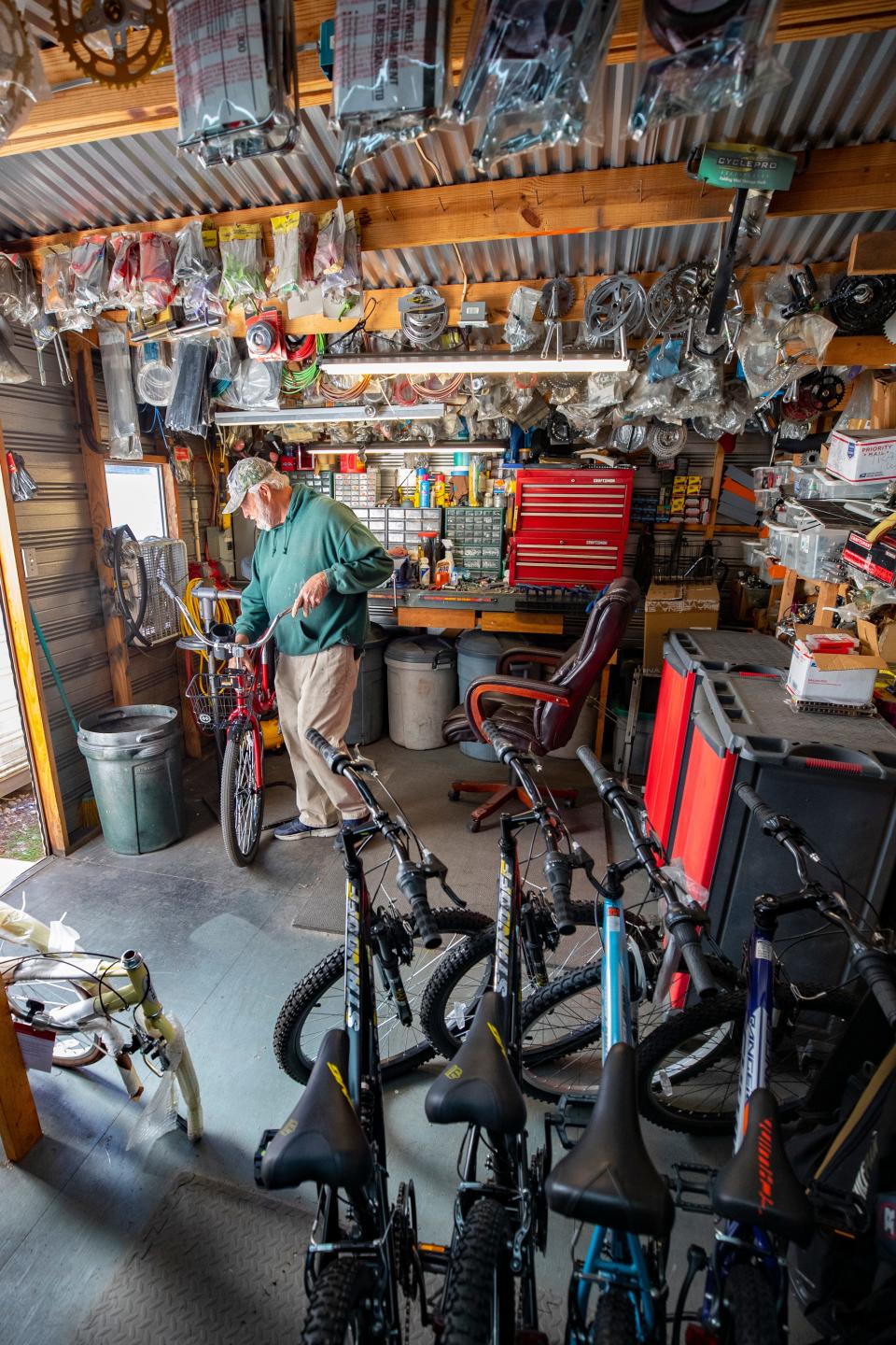 Mike Jones, aka Salvage Santa, takes old bicycles and makes them new again in his workshop on the northeast side of Panama City. Jones donates about 250 bicycles each year to area charities who distribute them to children for Christmas. His workshop has bicycle parts filling every available space.