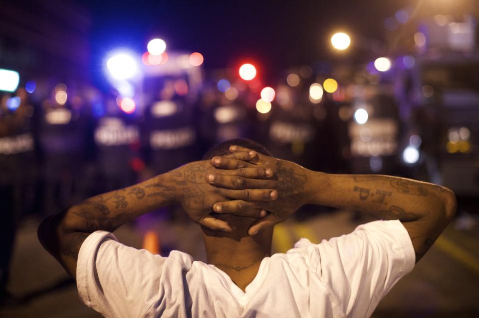 BALTIMORE, MD - APRIL 28:  Protestors defy curfew and taunt police officers the night after citywide riots over the death of Freddie Gray on April 28, 2015 in Baltimore, Maryland. Freddie Gray, 25, was arrested for possessing a switch blade knife April 12 outside the Gilmor Houses housing project on Baltimore's west side. According to his attorney, Gray died a week later in the hospital from a severe spinal cord injury he received while in police custody. (Photo by Mark Makela/Getty Images)