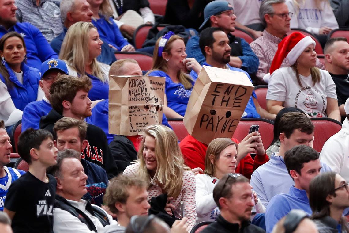 Patrons in the KFC Yum Center wore paper bags with messages about Louisville head coach Kenny Payne during the Cardinals’ 95-76 loss to Kentucky last December. U of L is now in the market for a new coach after announcing Wednesday that Payne had been dismissed after compiling a 12-52 record in two seasons.