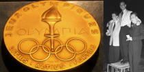 <p>A gold medal from the 1952 Olympics in Oslo, Sweden. It was given to Dick Button for winning the men’s singles figure skating event.<br>(AP Photo/Tina Fineberg; Winners of the men’s figure skating event–Helmut Seibt Austria, silver; Dick Button USA, gold; James Grogan USA, bronze/photo by Reg Birkett/Keystone/Getty Images) </p>