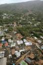 An aerial view shows collapsed houses following a landslide caused by Typhoon Wipha on Izu Oshima island, south of Tokyo, in this photo taken by Kyodo October 16, 2013. Four people were reported killed, schools closed, hundreds of flights cancelled and thousands were advised to evacuate as Typhoon Wipha pummelled Tokyo on Wednesday, although the Japanese capital escaped major damage. Mandatory Credit. (REUTERS/Kyodo)