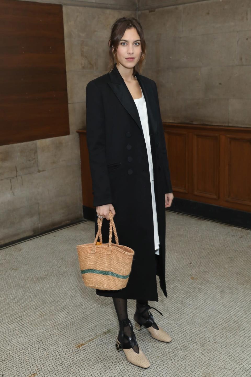 <p>Alexa Chung made her LFW debut in a tailored black coat and sophisticated shoes. <i>[Photo: Getty]</i> </p>