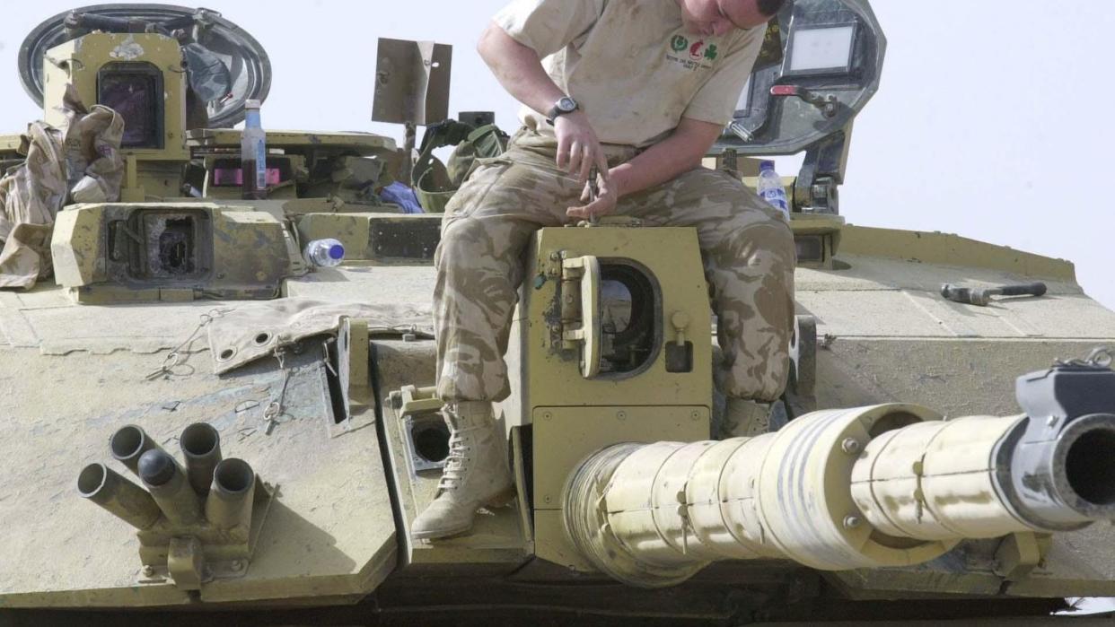 soldier repairs damaged tank