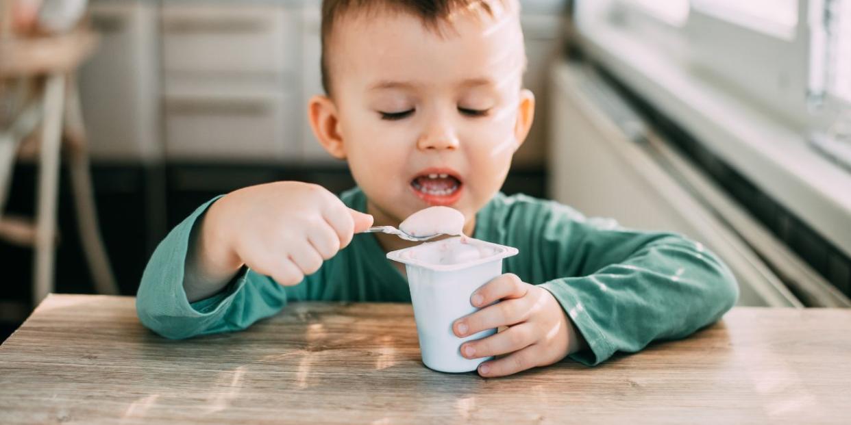 child eating yogurt in the kitchen bedtime snacks for kids