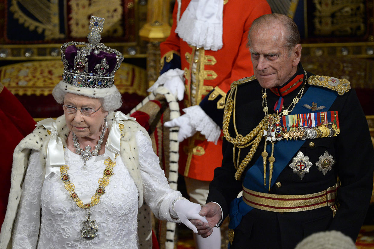 Britain's Queen Elizabeth II (L) and Prince Philip, Duke of Edinburgh (R) leave the House of Lords after delivering the Queen's Speech during the State Opening of Parliament at the Palace of Westminster in London on June 4, 2014. The State Opening of Parliament marks the formal start of the parliamentary year and the Queen's Speech sets out the governments agenda for the coming session.  AFP PHOTO / POOL / CARL COURT (Photo by CARL COURT / POOL / AFP) (Photo by CARL COURT/POOL/AFP via Getty Images)