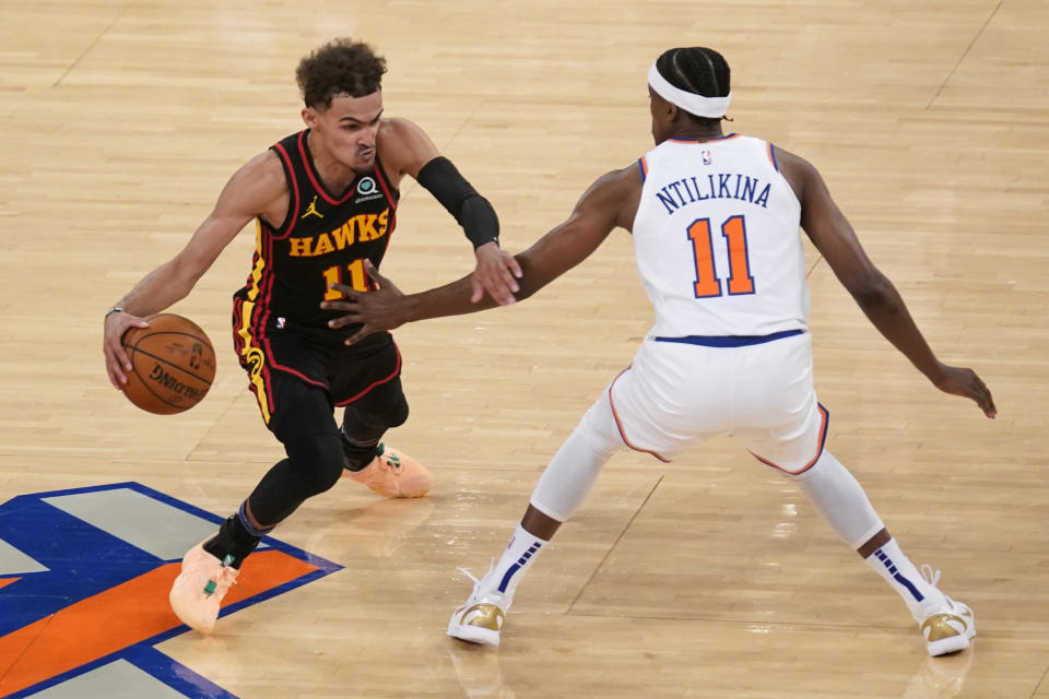 NEW YORK, NY - MAY 23: New York Knicks' Frank Ntilikina, right, guards Atlanta Hawks' Trae Young during the second half of Game 1 of an NBA basketball first-round playoff series on May 23, 2021 in New York City. The Hawks defeated the Knicks 107-105. NOTE TO USER: User expressly acknowledges and agrees that,  by downloading and or using this photograph,  User is consenting to the terms and conditions of the Getty Images License Agreement. (Photo by Seth Wenig - Pool/Getty Images)