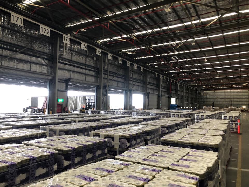 An image of a warehouse full of toilet paper can be seen. 