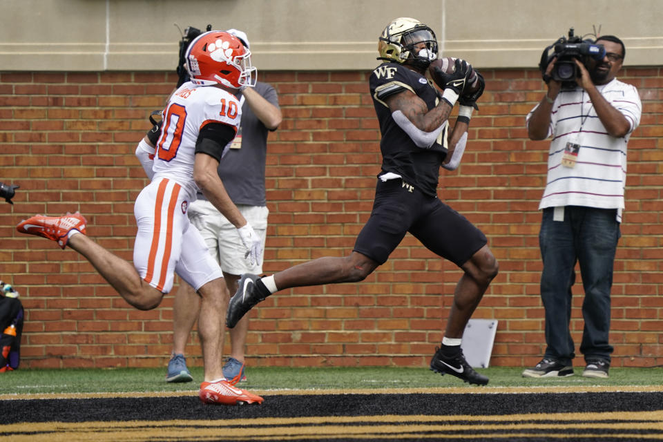 Wake Forest wide receiver Donavon Greene (11) catches a touchdown pass ahead of Clemson cornerback Jeadyn Lukus (10) during the second half of an NCAA college football game in Winston-Salem, N.C., Saturday, Sept. 24, 2022. (AP Photo/Chuck Burton)