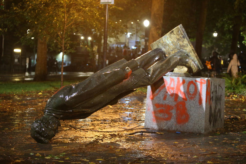 Image: A group of protesters toppled statues of former presidents Theodore Roosevelt and Abraham Lincoln in Portland's South Park Block (Sean Meagher / AP)