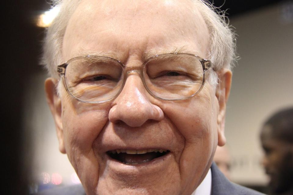 A jubilant Warren Buffett surrounded by people at Berkshire Hathaway's annual meeting.