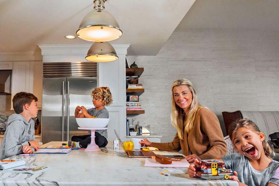 A woman and three children at a kitchen island