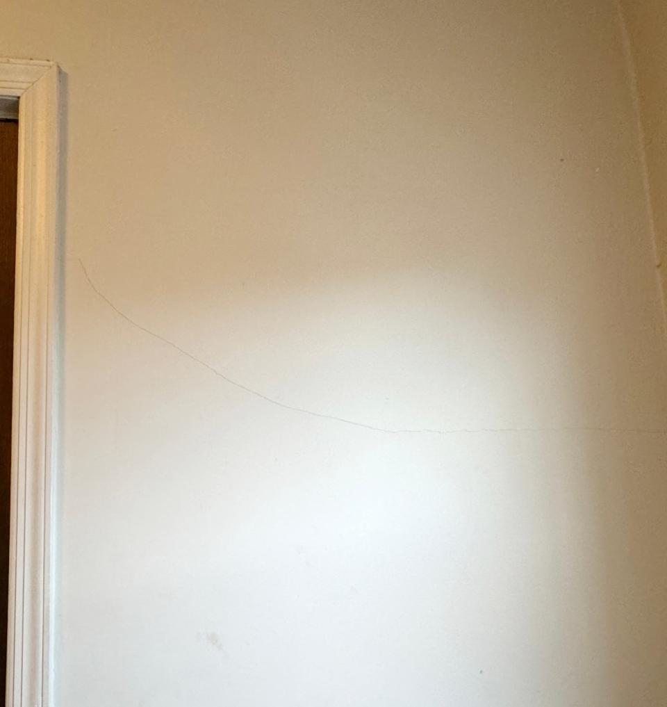 One unusual, horizontal crack in a nearby resident’s wall has grown to over three feet long.