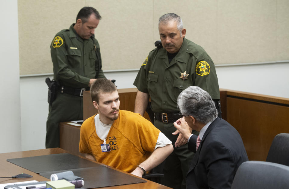 Samuel Woodward talks to his attorney Edward Munoz before being led out of a court hearing at the Harbor Justice Center in Newport Beach, Calif., on Wednesday, Aug. 22, 2018. Woodward is charged with the murder of a University of Pennsylvania student Blaze Bernstein. (Paul Bersebach/The Orange County Register via AP, Pool)