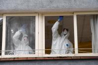 FILE PHOTO: FILE PHOTO: Sanitary workers clean the nursing home where a woman died and several residents and care providers have been diagnosed with coronavirus disease (COVID-19) in Grado