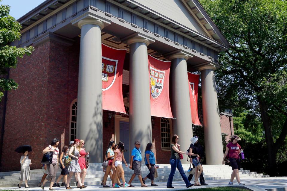 A tour group walks through the Harvard campus in 2012. A federal judge's ruling on its use of race in admissions is before the Supreme Court.